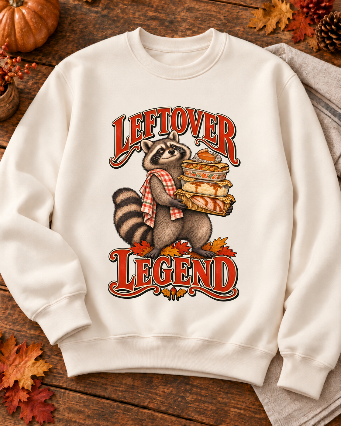 Generated styling preview: Leftover Legend design on a Pigment Ivory crewneck sweatshirt, styled with autumn leaves