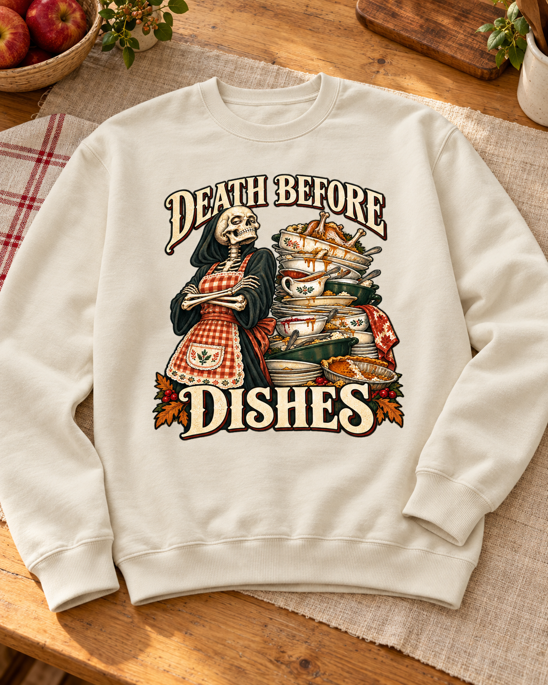 Generated styling preview: Death Before Dishes design on a Pigment Ivory crewneck sweatshirt, styled with linen and apples
